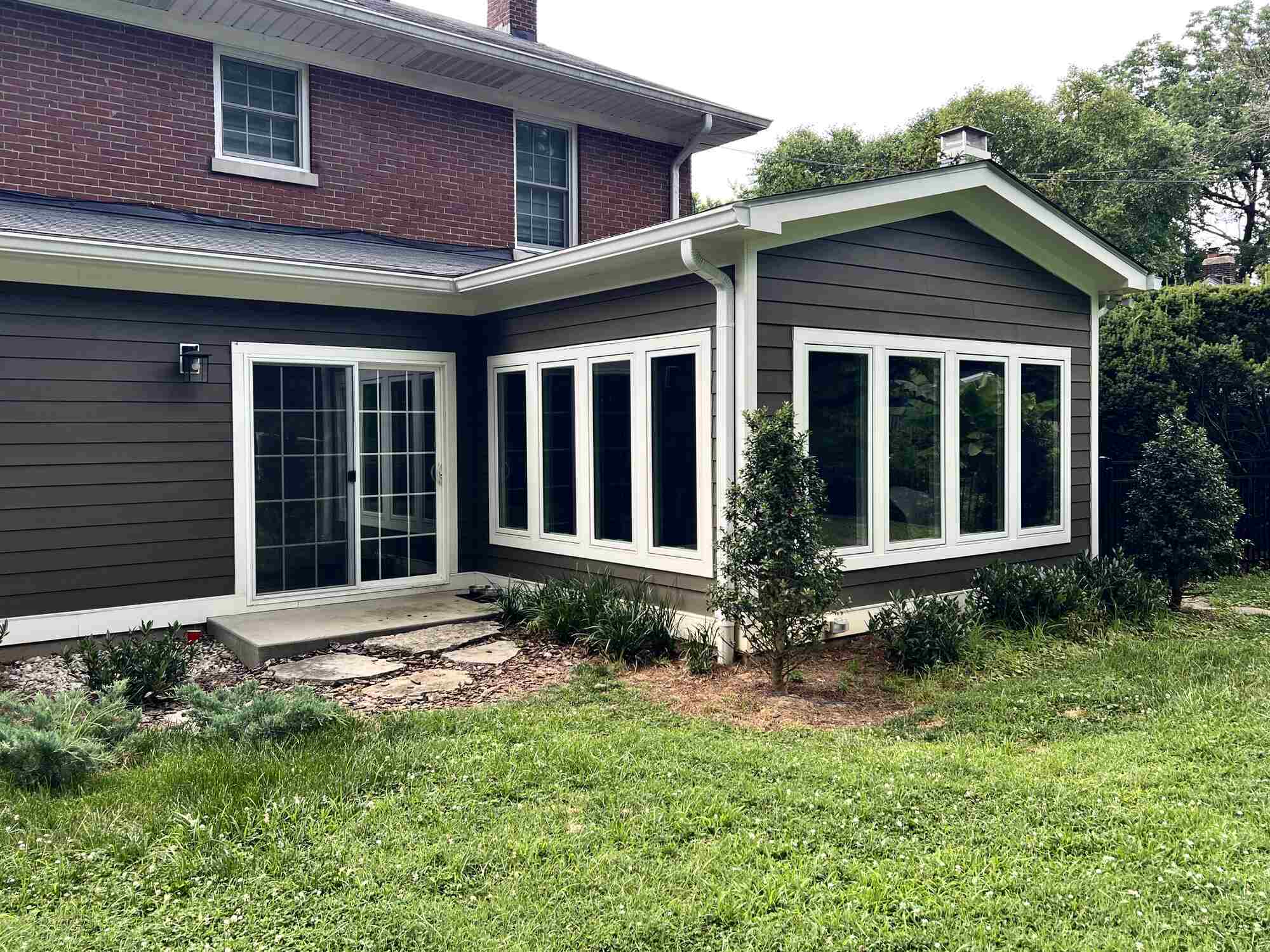 Exterior view of remodeled home addition with large windows in Louisville, KY by Trade Works Remodeling