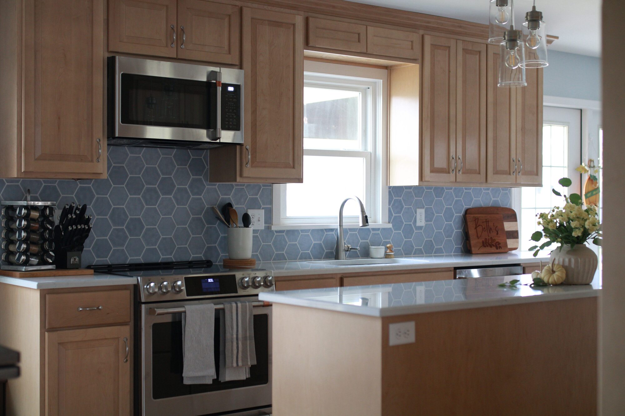 Full view of kitchen with modern fixtures and lighting in a custom home by Trade Works Remodeling in Druid Hills, KY
