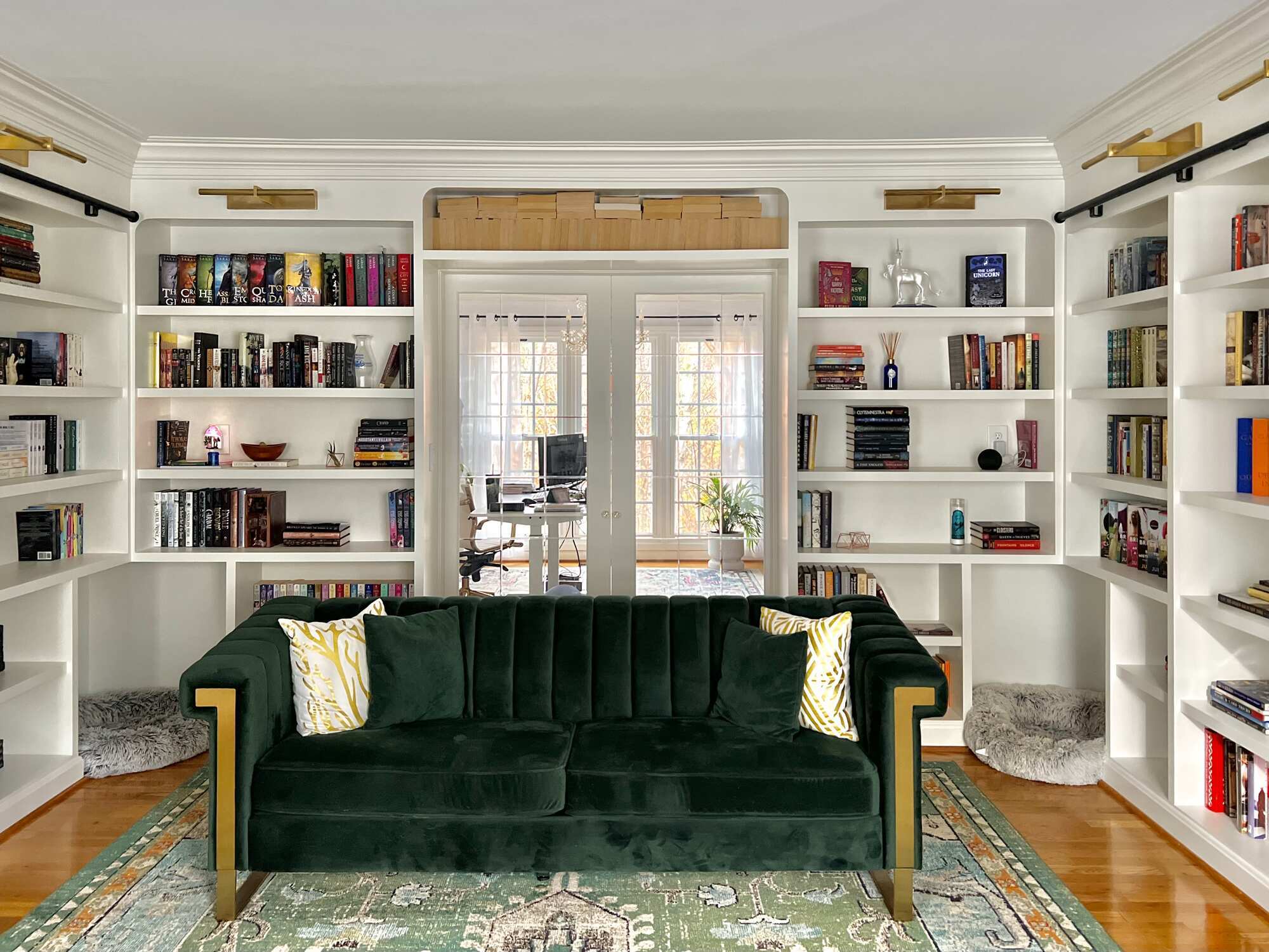 Home library upgrade with integrated shelving and patterned rug by Trade Works Remodeling in Old Brownsboro Place, KY