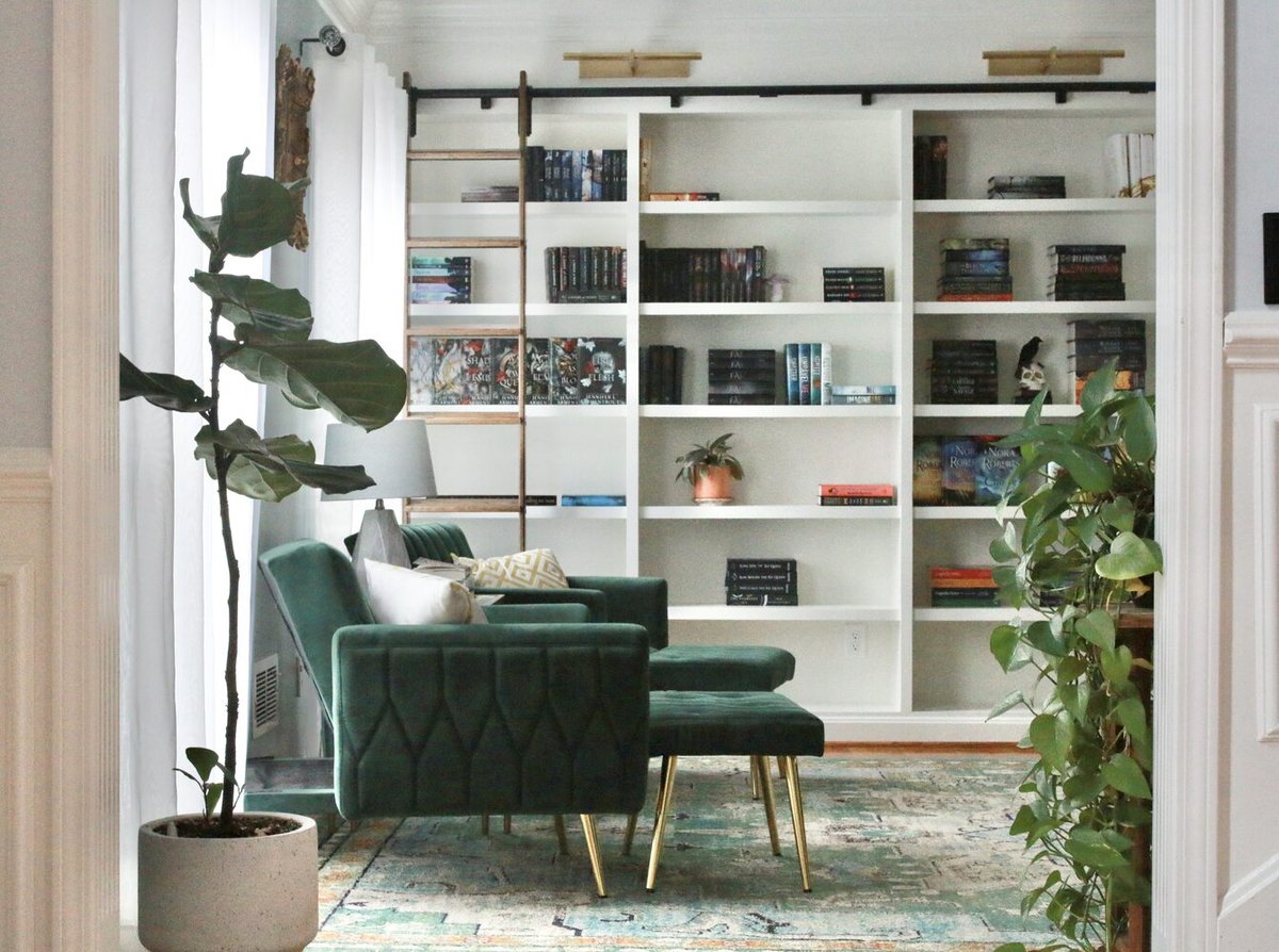 Cozy custom library with white shelves and green seating in Indian Hills, KY by Trade Works Remodeling