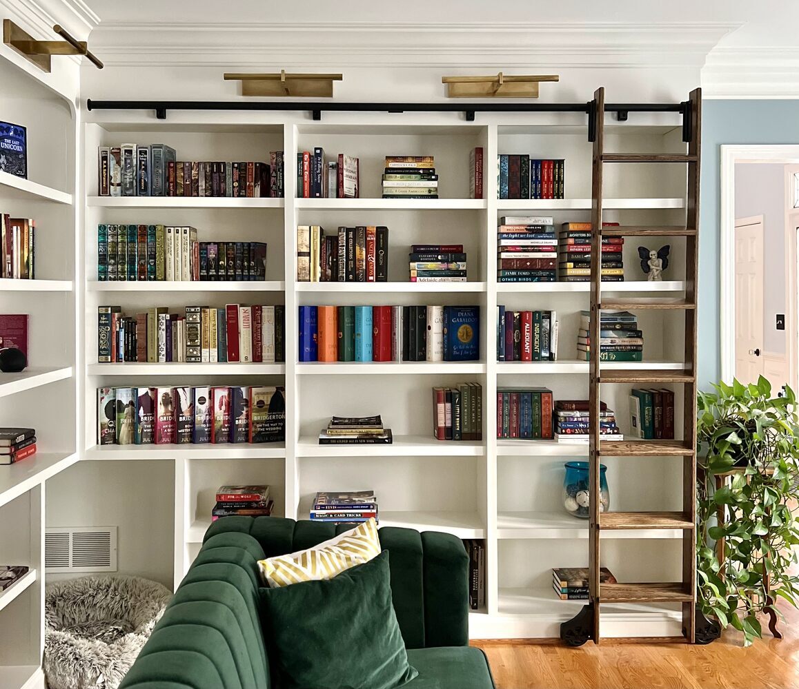 Custom home library in Indian Hills, KY with full-height bookshelves and rolling ladder by Trade Works Remodeling