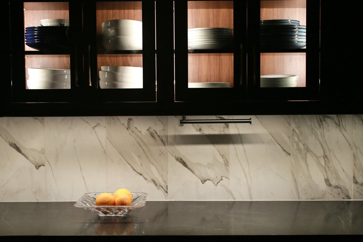 Illuminated dish display cabinets and marble backsplash in Spring Valley, KY custom kitchen by Trade Works Remodeling