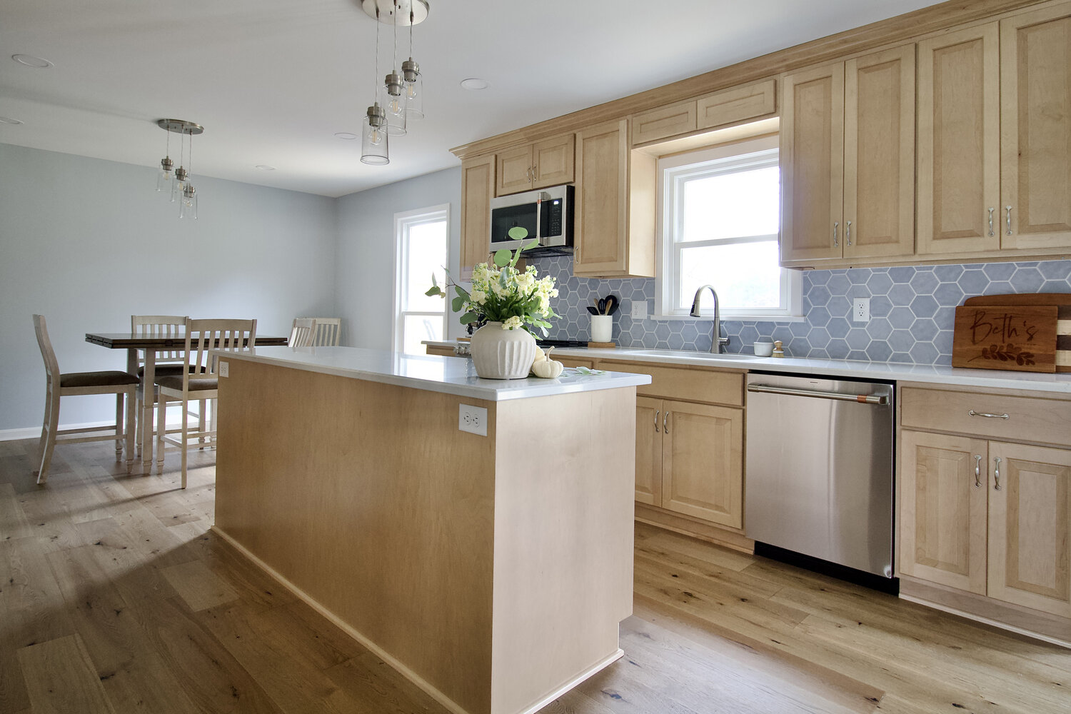 Custom kitchen remodel by Trade Works Remodeling in Plainview, KY featuring light wood cabinets and quartz countertops