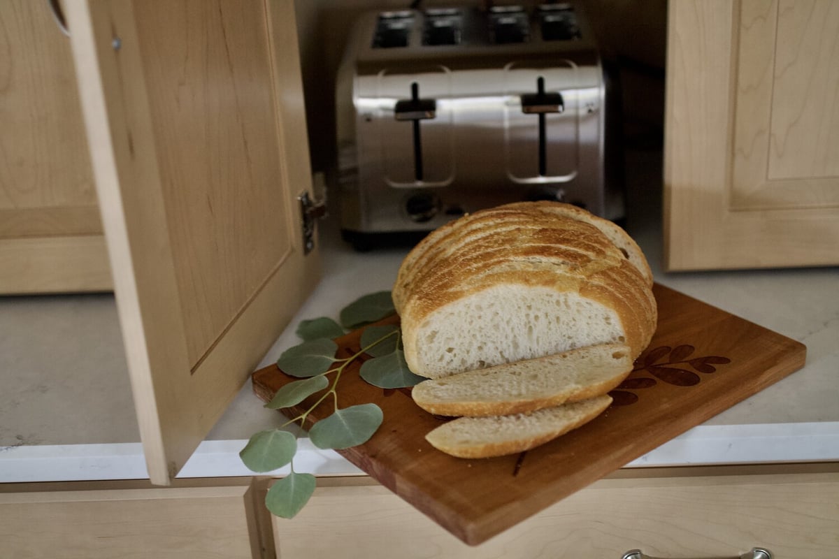 Freshly baked bread on custom cutting board in a kitchen remodel by Trade Works Remodeling in Louisville, KY