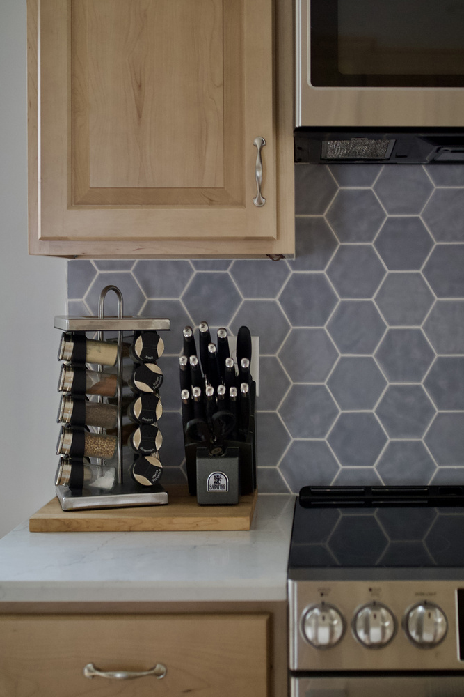 Organized spice station and modern backsplash in a custom kitchen by Trade Works Remodeling in St. Matthews, KY