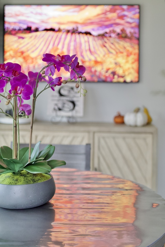 Close-up of faux orchid centerpiece on modern dining table in Bancroft, KY by Trade Works Remodeling