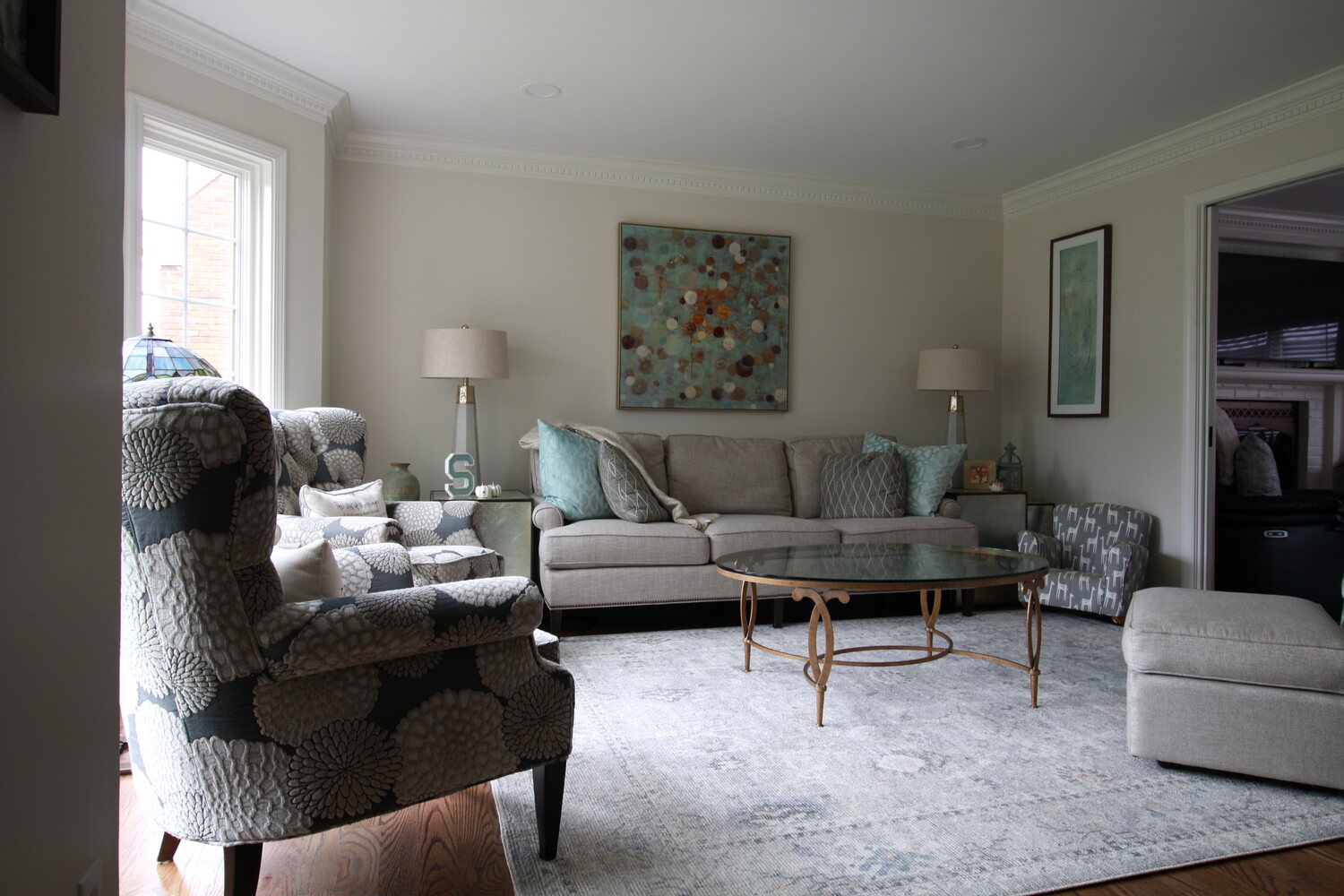 Cozy custom living room with patterned chairs and abstract art in Blue Ridge Manor, KY by Trade Works Remodeling
