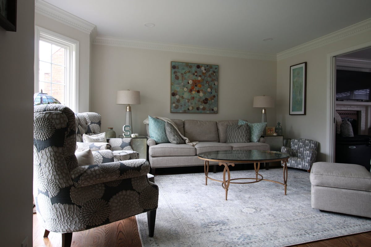 Cozy custom living room with patterned chairs and abstract art in Blue Ridge Manor, KY by Trade Works Remodeling