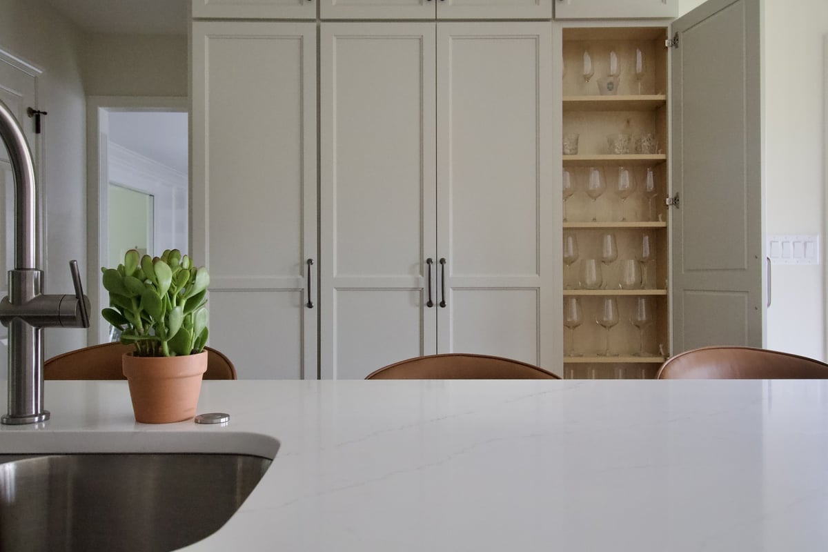 Custom kitchen island with modern faucet and built-in cabinetry in Douglass Hills, KY by Trade Works Remodeling