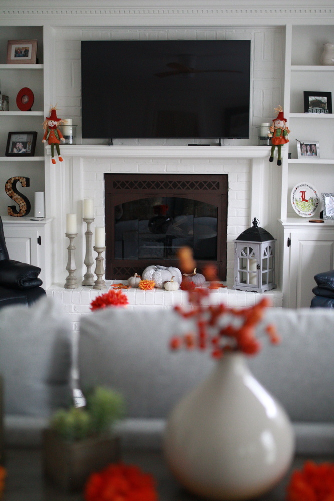 Fireplace with seasonal décor and built-ins in Rolling Hills, KY custom home by Trade Works Remodeling