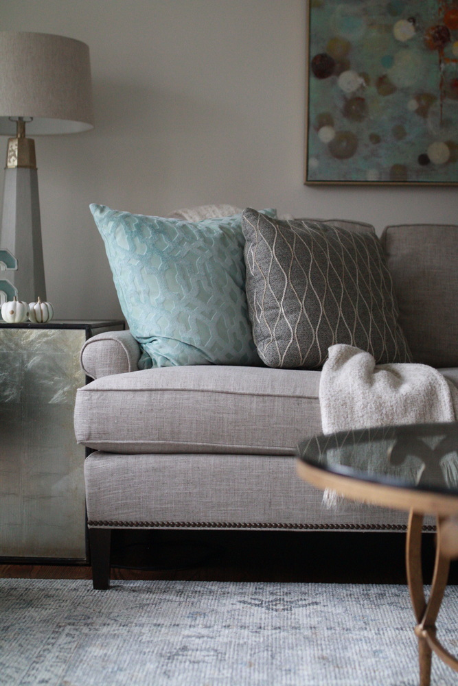 Styled sofa with accent pillows and art in a custom home living room by Trade Works Remodeling in Bancroft, KY