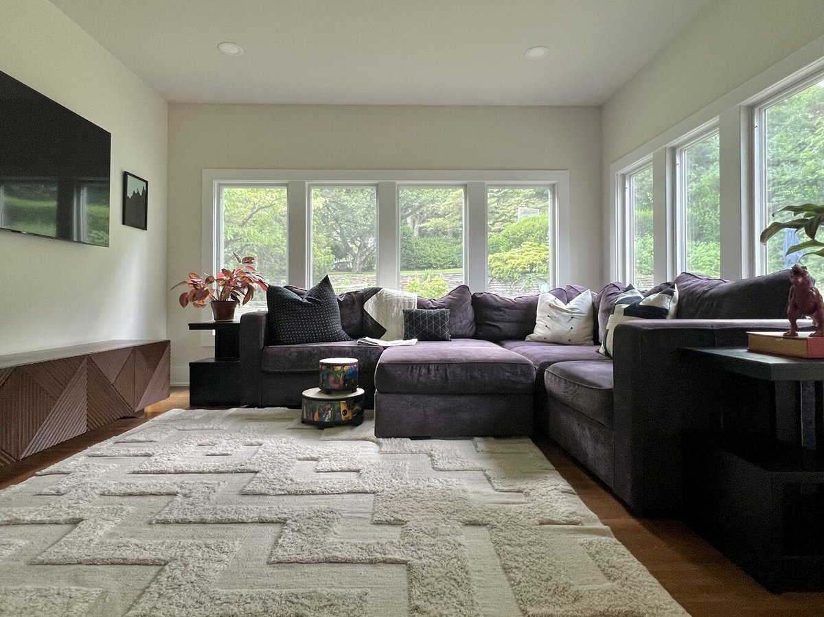 Bright sunroom with large windows and velvet sectional by Trade Works Remodeling, Highlands, KY