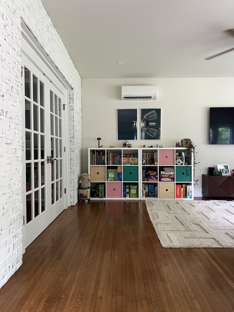 Built-in bookshelf and games area in remodeled living space by Trade Works Remodeling, Highlands, KY