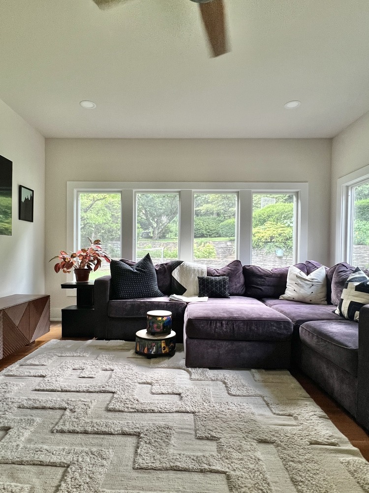 Cozy sunroom with sectional couch and large windows in Louisville custom home by Trade Works Remodeling