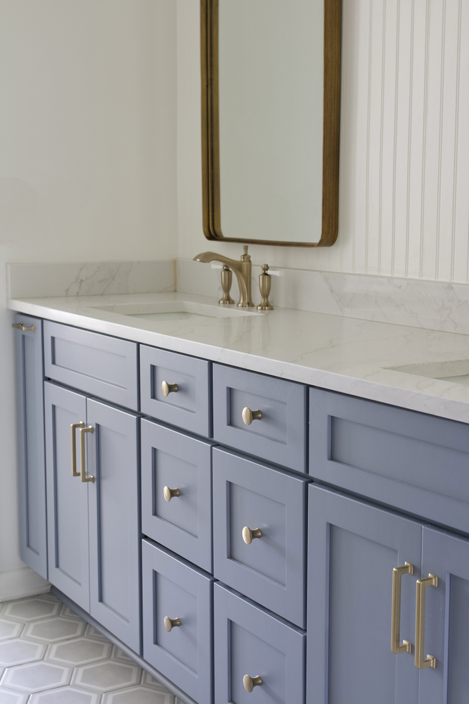 Blue bathroom vanity with marble countertop by Trade Works Remodeling in Owl Creek, KY