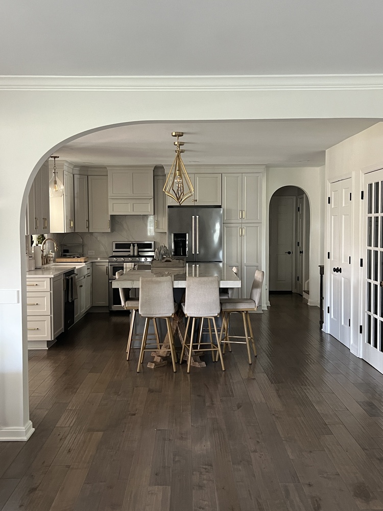 Bright white kitchen renovation with island and stools in Louisville, KY by Trade Works Remodeling