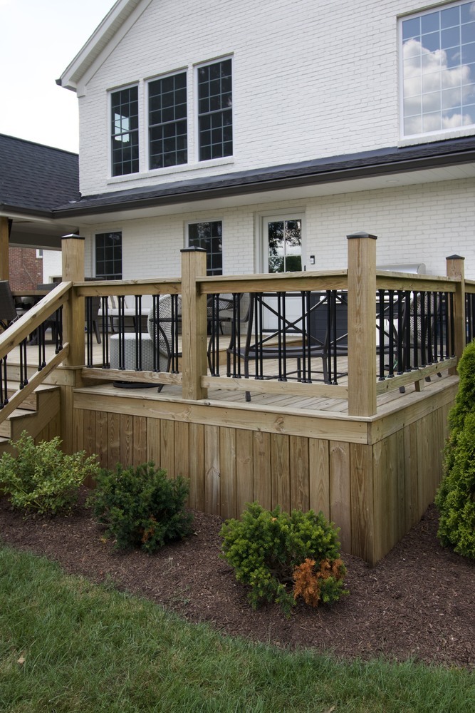 Close-up of wood deck railing and exterior wall of custom home by Trade Works Remodeling in Louisville, KY