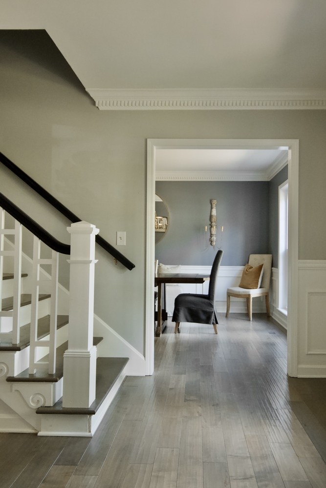 Custom home entryway with staircase and view into dining room by Trade Works Remodeling in Louisville, KY