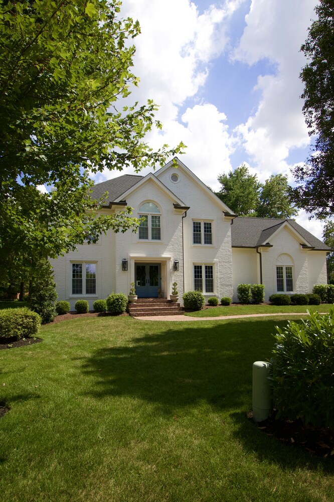 Custom home remodel with manicured lawn and mature trees by Trade Works Remodeling in Louisville, KY