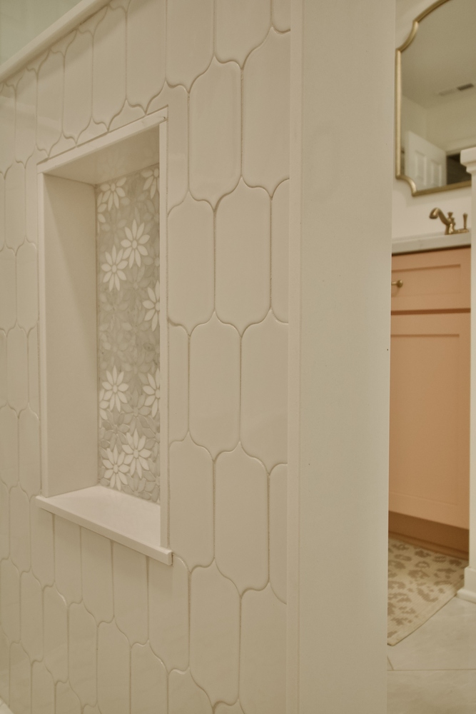 Custom shower remodel with built-in niche and floral tile by Trade Works Remodeling in Louisville, KY