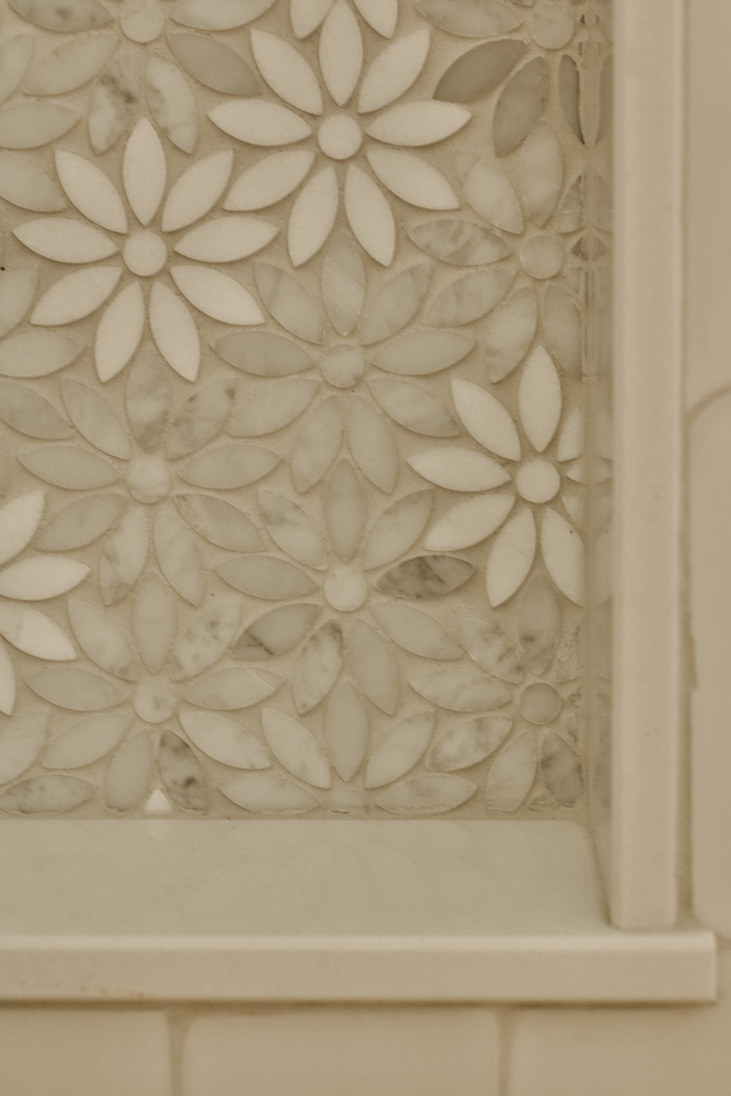 Decorative marble floral tile detail in custom bathroom by Trade Works Remodeling in Louisville, KY
