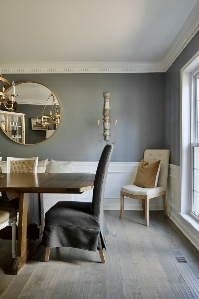 Dining room remodel with gray walls and wooden table by Trade Works Remodeling in Anchorage, KY