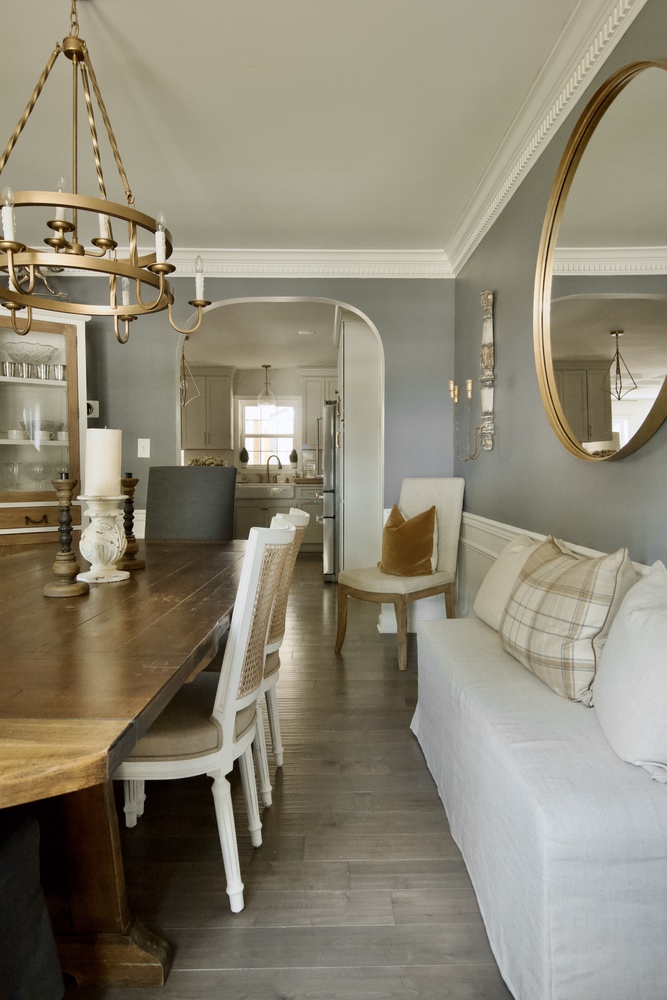 Dining room remodel with wood table and chandelier by Trade Works Remodeling in Anchorage, KY