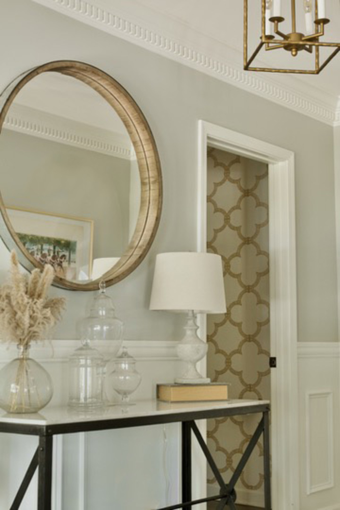 Elegant entryway remodel with round mirror and accent lighting by Trade Works Remodeling in Anchorage, KY