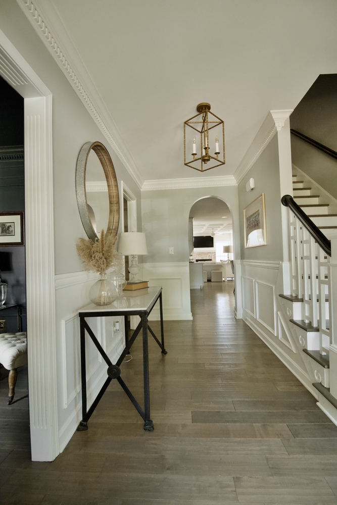 Elegant hallway remodel with crown molding and chandelier by Trade Works Remodeling in Old Brownsboro Place, KY