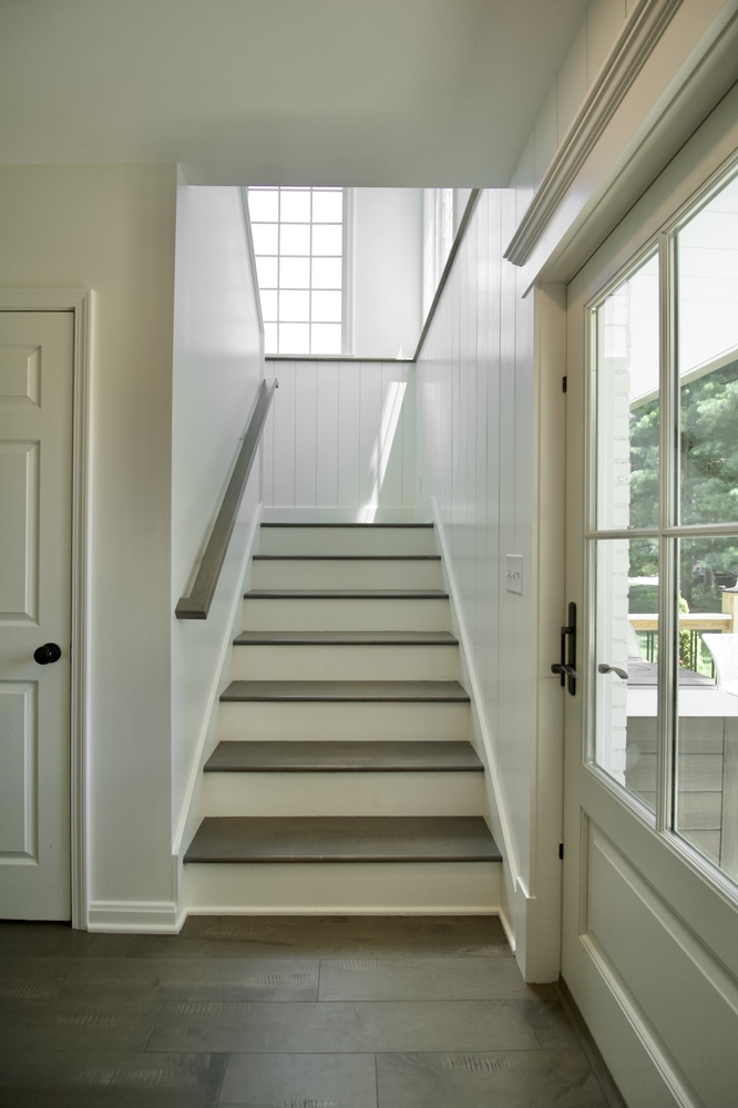 Entry stairwell with natural lighting and white shiplap in a Trade Works Remodeling home in Louisville, KY