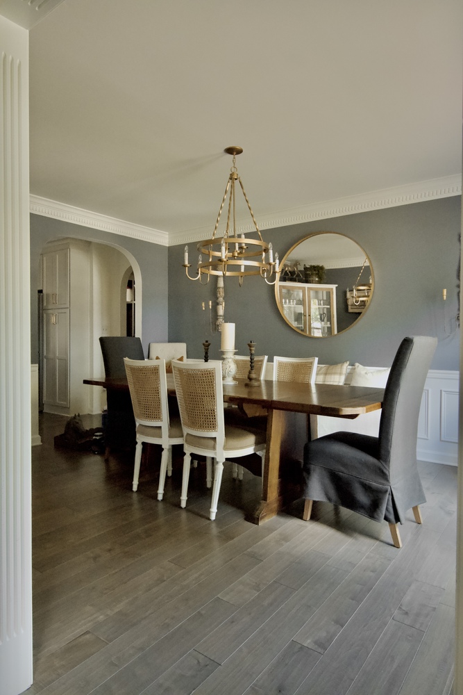 Formal dining room with chandelier and large wooden table by Trade Works Remodeling in Indian Hills, KY