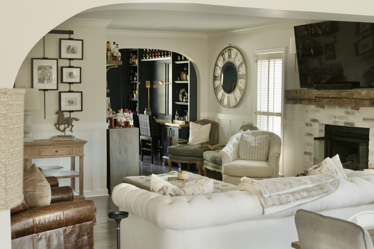 Living room remodel with arched entry to custom bar by Trade Works Remodeling in Louisville, KY