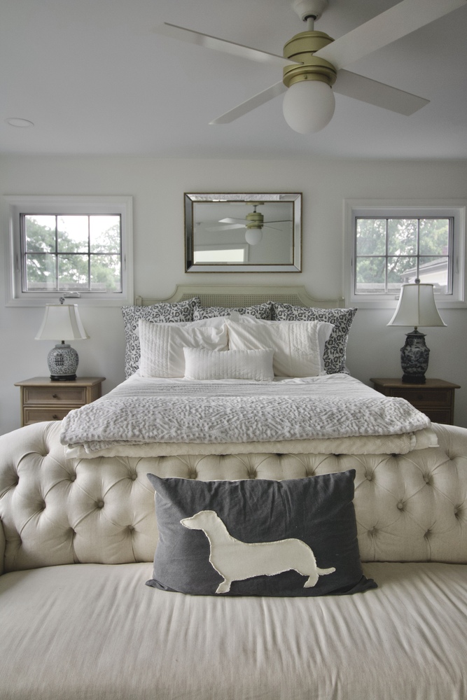Master bedroom remodel with tufted bench and layered bedding by Trade Works Remodeling in St. Matthews, KY