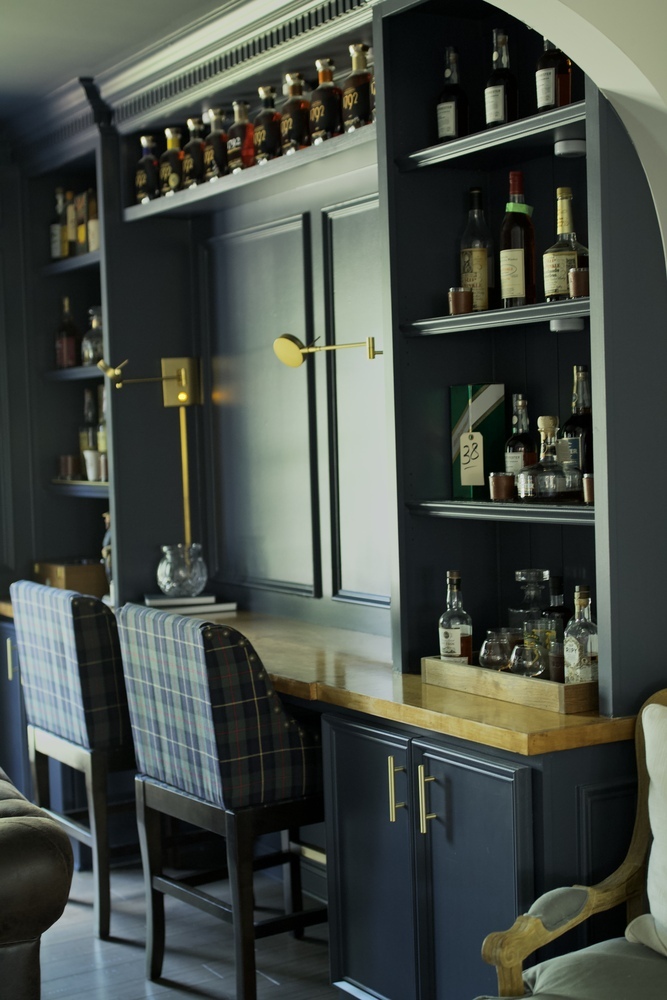 Side angle of bourbon room bar and seating area in Louisville custom home by Trade Works Remodeling
