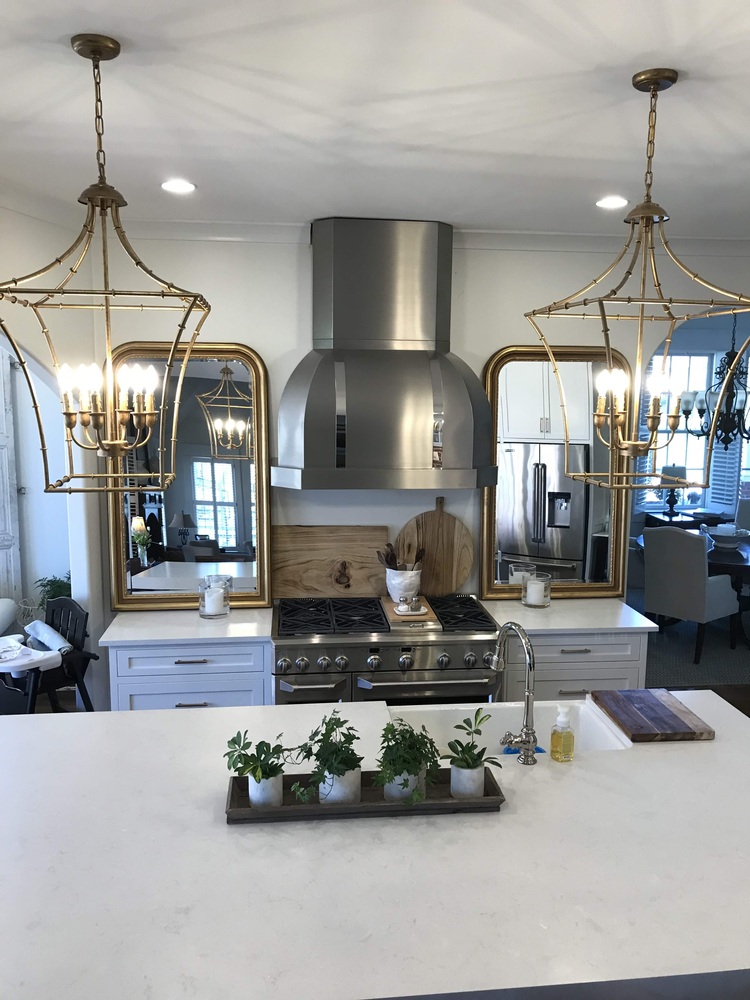 Luxury kitchen remodel with stainless hood and gold lighting by Trade Works Remodeling in Louisville, KY