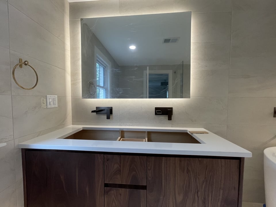 Bathroom renovation in progress with vanity base and LED mirror installed by Trade Works Remodeling in Louisville, KY