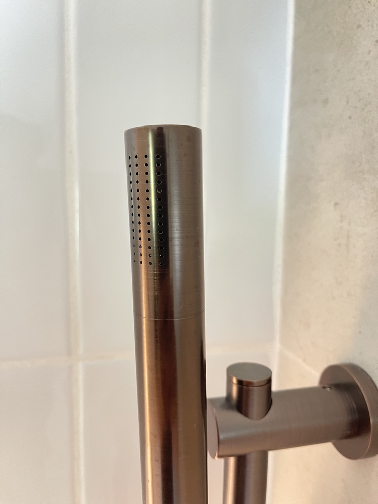 Bronze handheld shower fixture detail by Trade Works Remodeling in Ten Brook, KY