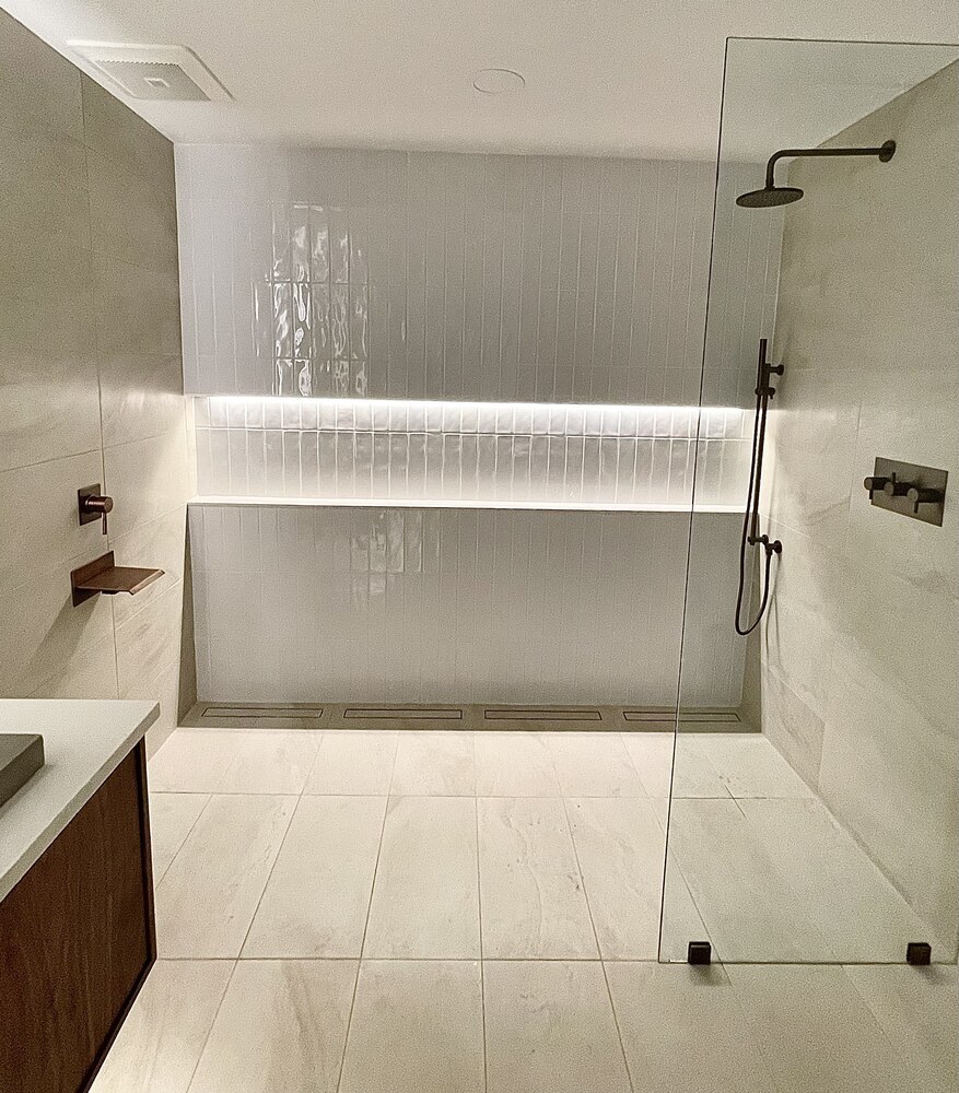 Custom tiled shower with wood accent shelf by Trade Works Remodeling in Anchorage, KY