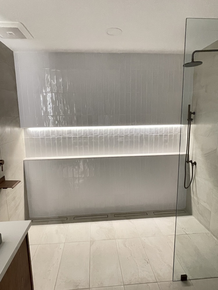 Walk-in shower renovation with bronze fixtures by Trade Works Remodeling in Louisville, KY