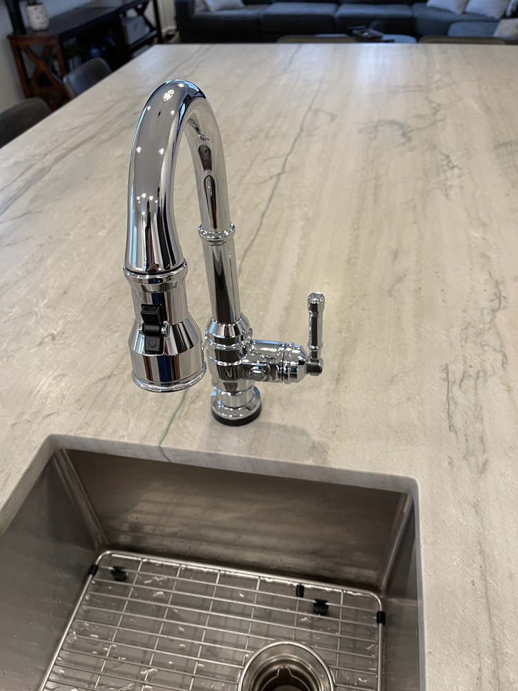 Close-up of chrome faucet and sink installation on custom kitchen island in Prospect, KY by Trade Works Remodeling