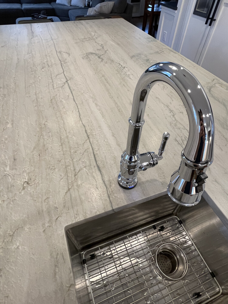 Close-up of kitchen island sink remodel with chrome faucet in Douglass Hills, KY by Trade Works Remodeling