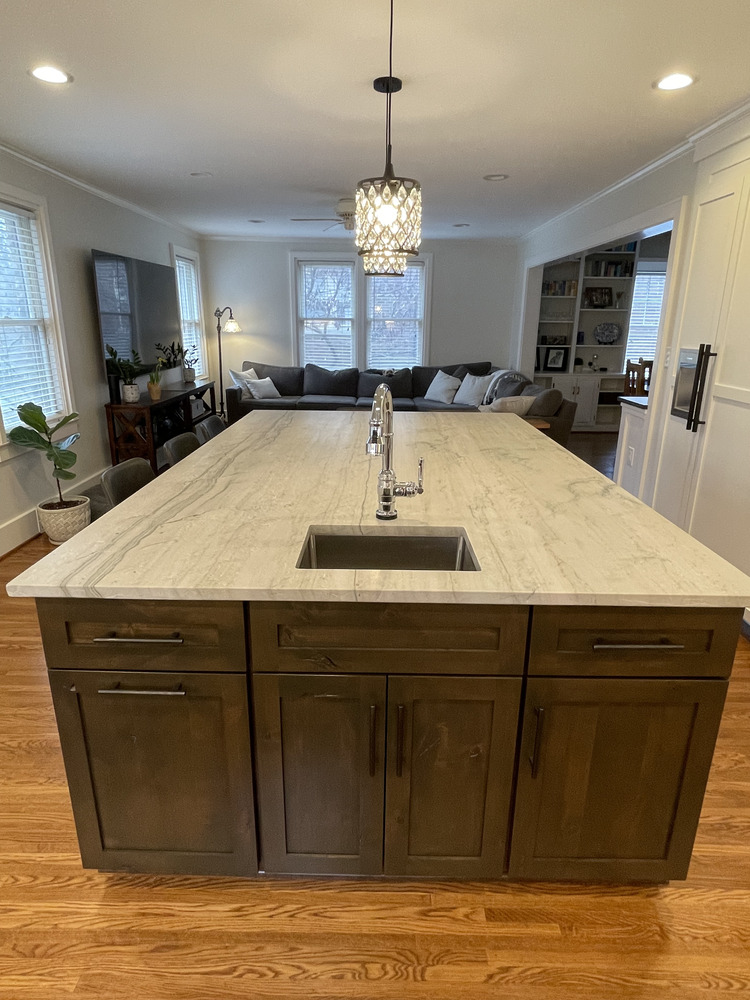 Kitchen remodel with large stone island and pendant lighting in Hurstbourne, KY by Trade Works Remodeling