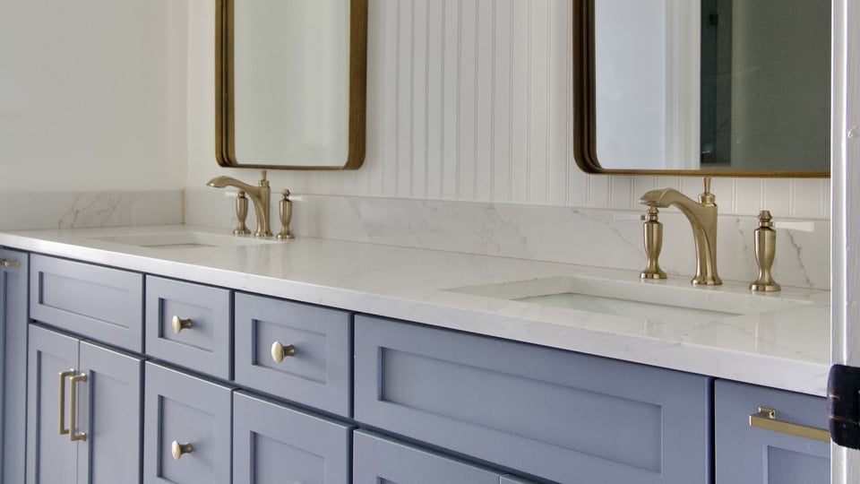 bathroom remodel in louisville ky with blue double sink vanity and marble countertops