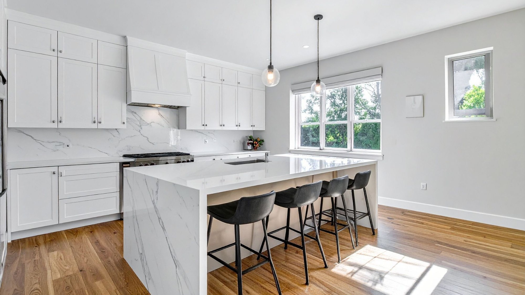 contemporary kitchen with waterfall edge kitchen island and white cabinets