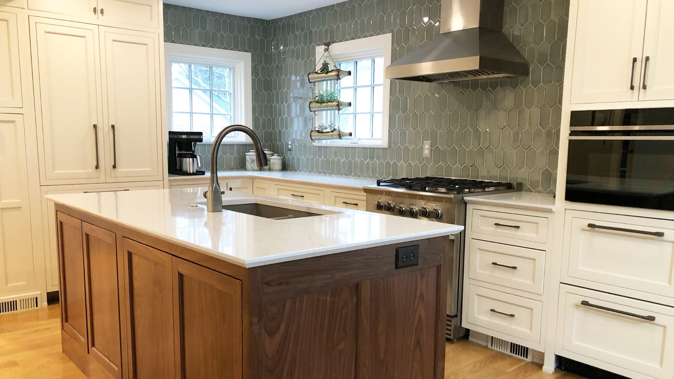 kitchen renovation in louisville, ky with green counter to ceiling backsplash, white cabinets, and a wood paneled kitchen island