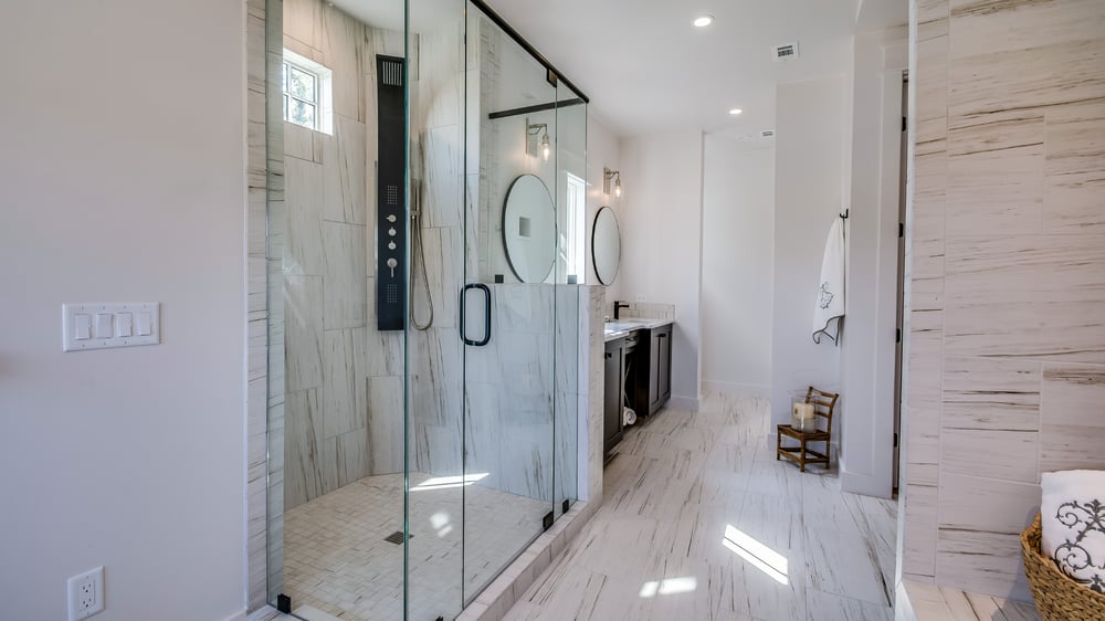 modern bathroom with walk-in shower and double vanity