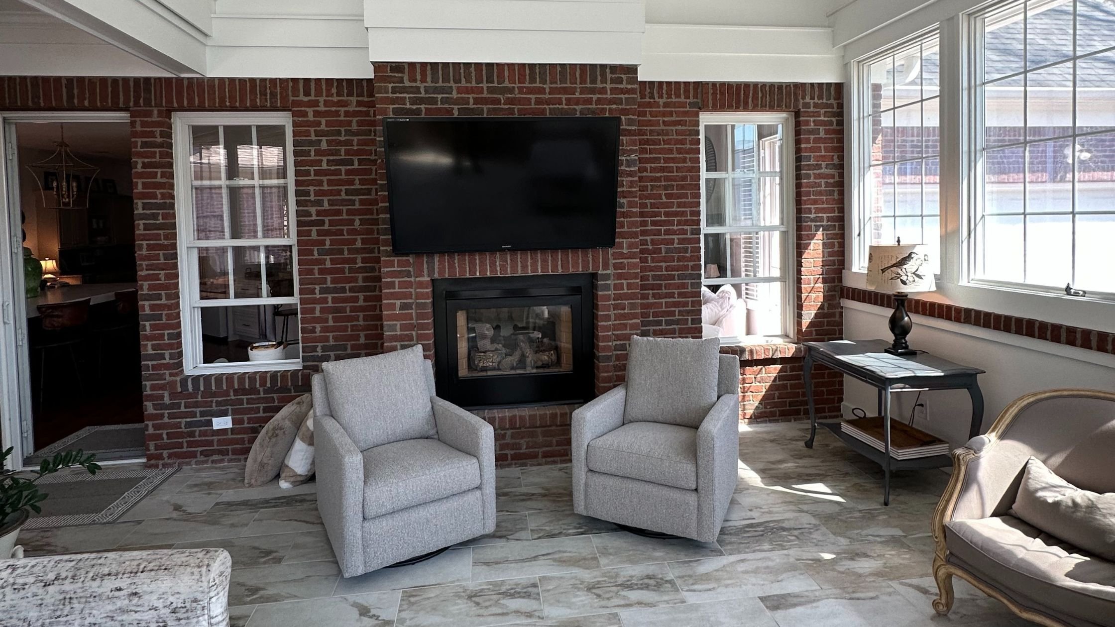 sunroom home addition in louisville, ky with brick fireplace and tile flooring