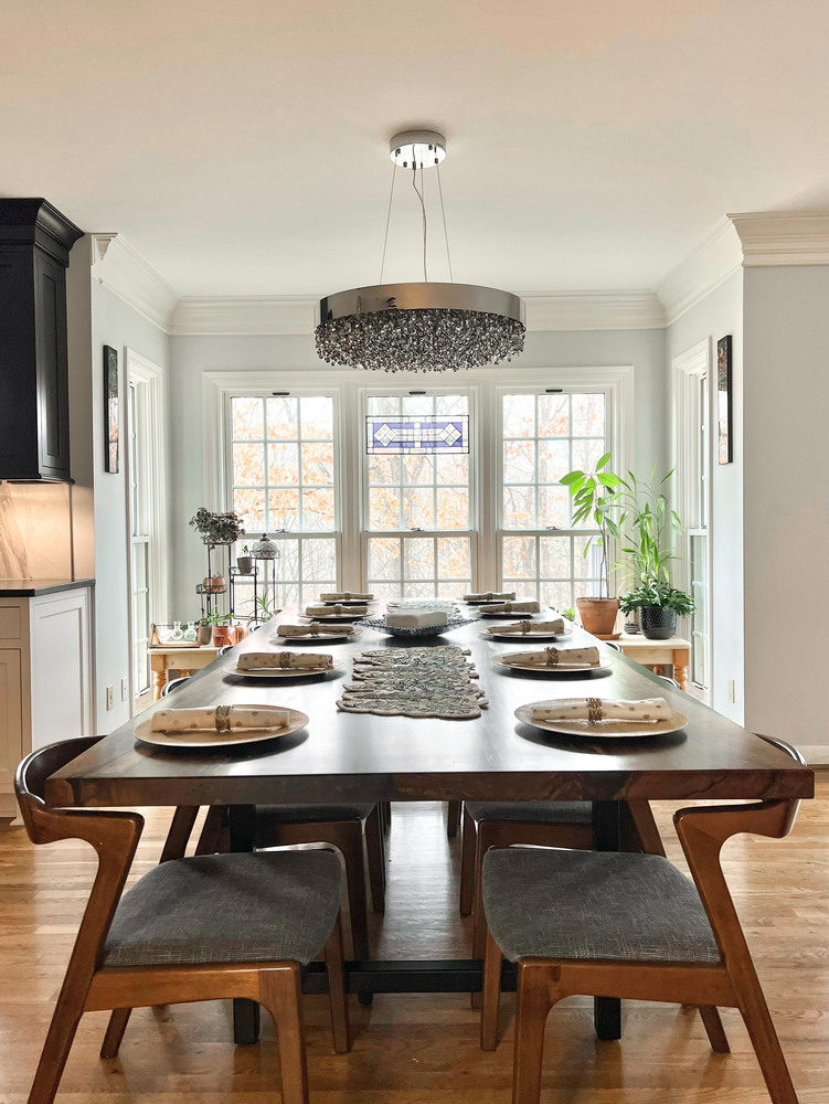 Bright dining room remodel with modern chandelier and large windows in Indian Hills, KY