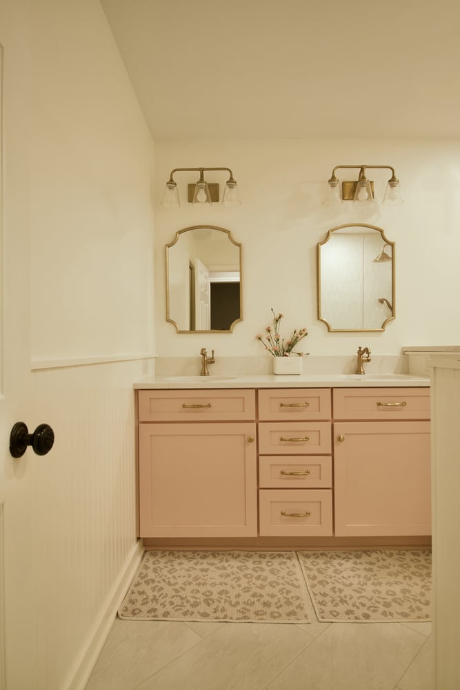 Bathroom vanity with pink cabinets and dual mirrors by Trade Works Remodeling in Owl Creek, KY