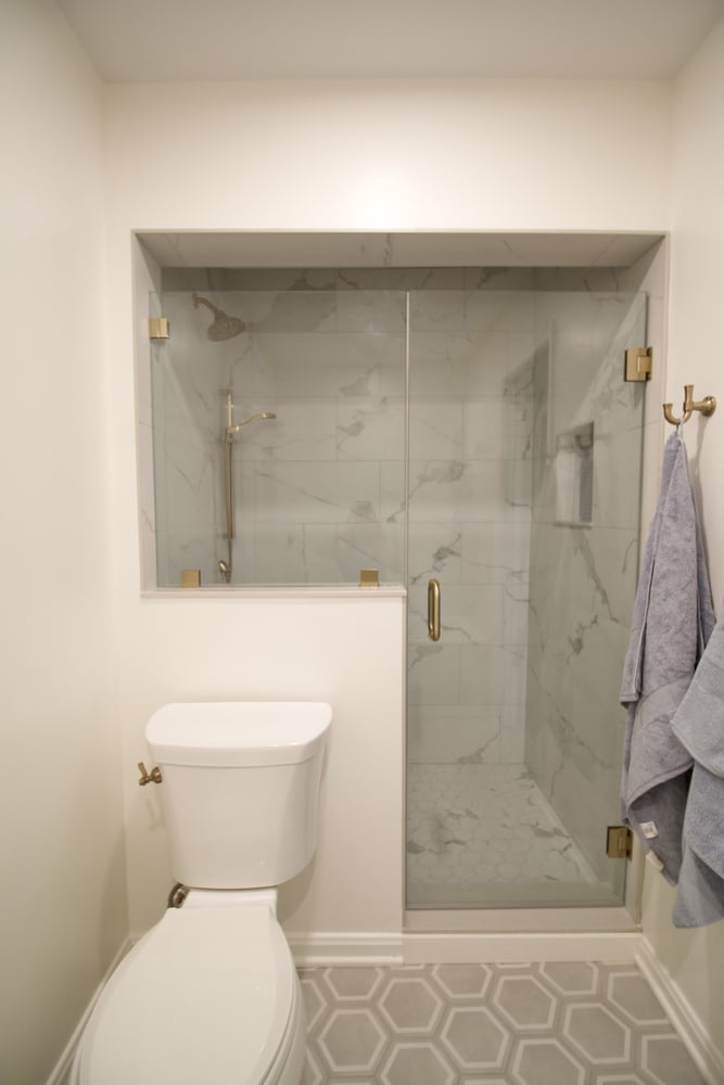 Custom bathroom remodel with glass shower and marble tile by Trade Works Remodeling in Louisville, KY